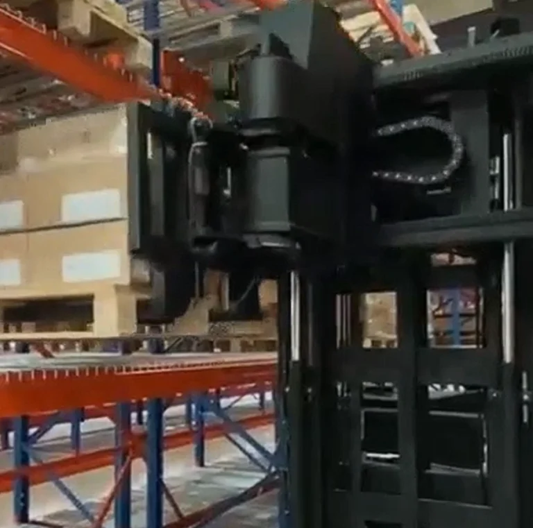Unit load ASRS system handling palletized washing machine cartons inside an automated warehouse rack aisle